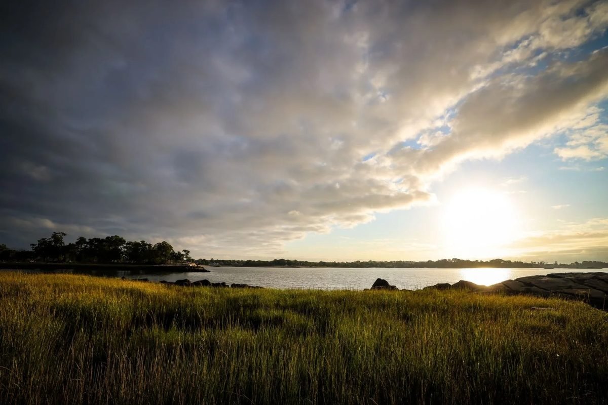 Sunrise over the marsh grass and water at Cove Island Park in Stamford