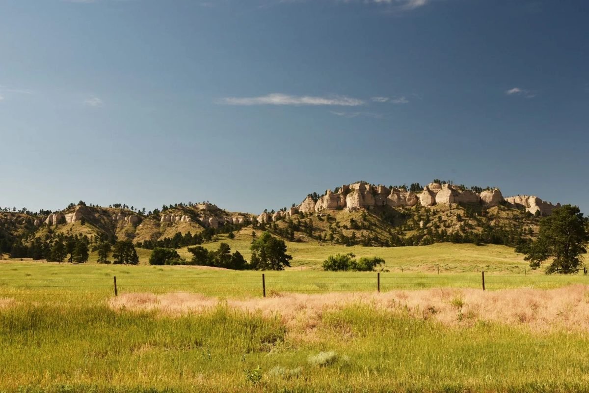 Rolling prairie grass below the Badlands buttes of western North Dakota